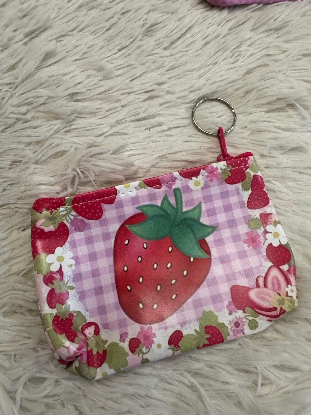 Strawberry keychain coin purse with large strawberry on a checkered background